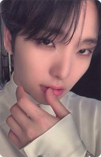 Photocard of Seoho brushing his thumb against his lips