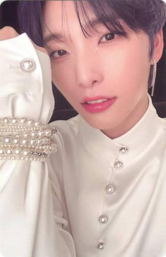 Photocard of Seoho wearing a white pearled outfit and holding his wrist up by his face
