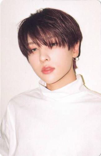 Photocard of Rie wearing a white sweatshirt and gazing into the camera