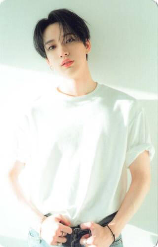 Photocard of Nine wearing a white t-shirt and denim pants, holding his belt