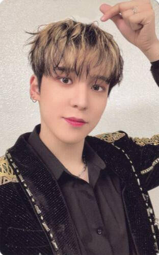 Photocard of Yunho wearing a black and gold outfit and making a finger heart