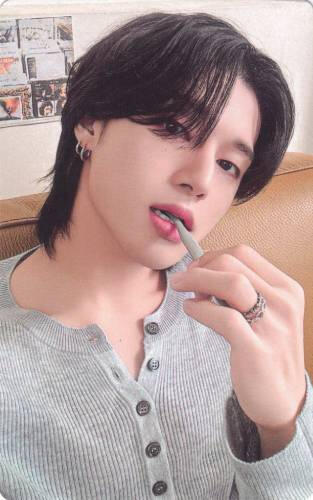 Photocard of Wooyoung biting a pen