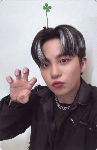 Jongho with a sprout coming out of his hair making a clawed hand