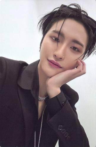 Photocard of Seonghwa wearing a black suit and resting his face on his hand