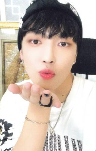 Photocard of Hongjoong wearing a white shirt and blowing a kiss at the camera