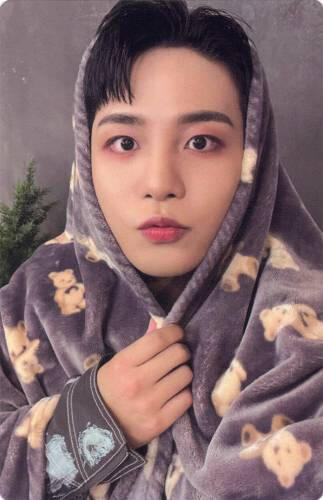 Photocard of Jongho wrapped up in a bear blanket