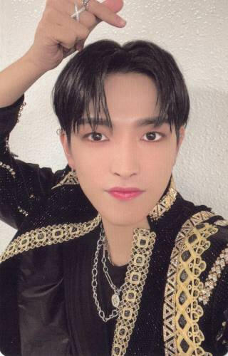 Photocard of Hongjoong wearing a black and gold outfit and doing a finger heart