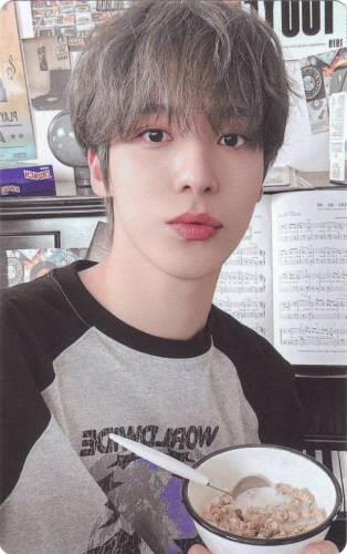 Photocard of Yunho with a bowl of cereal