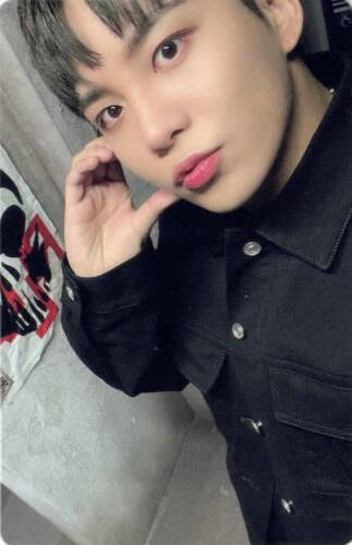 Photocard of Jongho wearing a black button up and holding a hand heart to his cheek