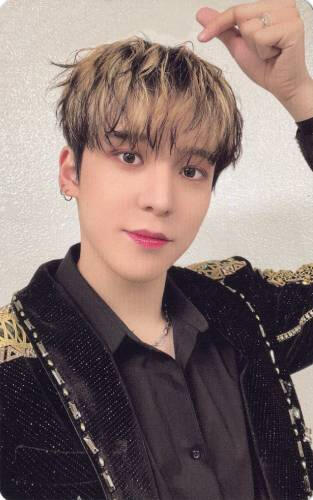 Photocard of Yunho wearing a black and gold outfit and making a finger heart