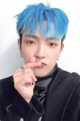 Photocard of Hongjoong wearing a black suit and making a finger heart