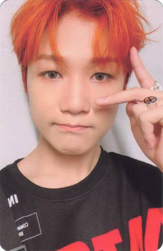 Photocard of Jongseob with orange hair making a peace sign