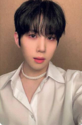 Photocard of Youngseo wearing a slightly-open white button up and gazing into the camera