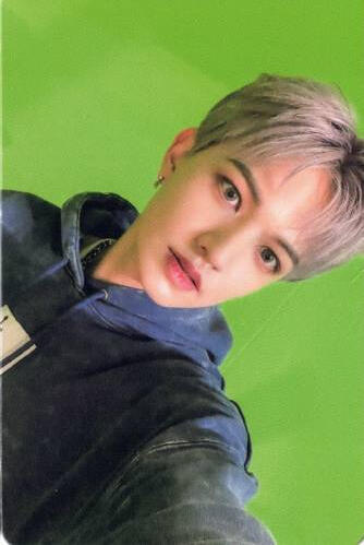 Photocard of Bit wearing a black and blue hoodie and looking into the camera
