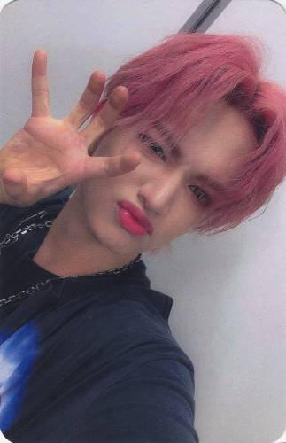Photocard of Bit making a clawed hand and scrunching his face