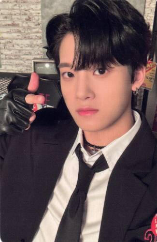 Photocard of Junmin wearing a black suit and pointing a finger gun at the camera