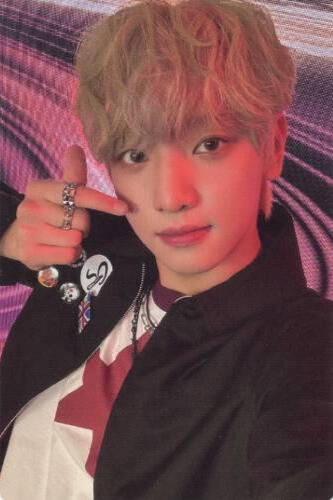 Photocard of Yujun wearing a black jacket and white shirt and holding up a finger heart
