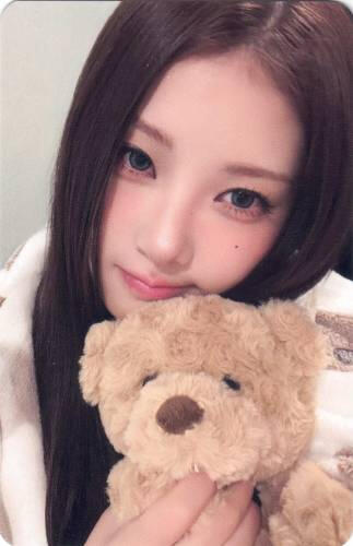 A photocard of Chaein holding a teddy bear