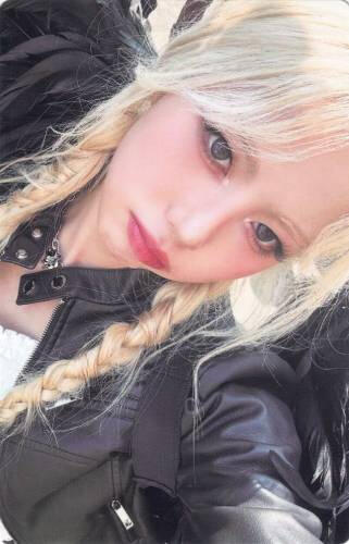 A photocard of Ireh in a black leather jacket and black fallen angel wings