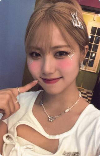 Photocard of Ireh wearing a low-cut white shirt and poking her cheek