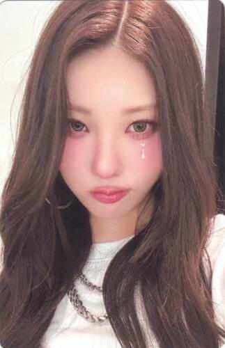Photocard of Chaein wearing a white t-shirt and staring at the camera with a pouty look