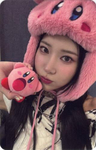 Photocard of Ayeon in a kirby hat holding a small kirby plushie