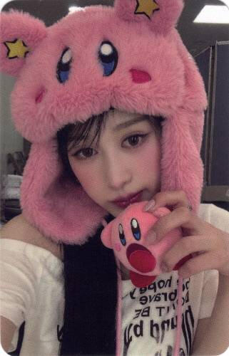 Photocard of Chaei wearing a kirby hat and holding a small kirby plush