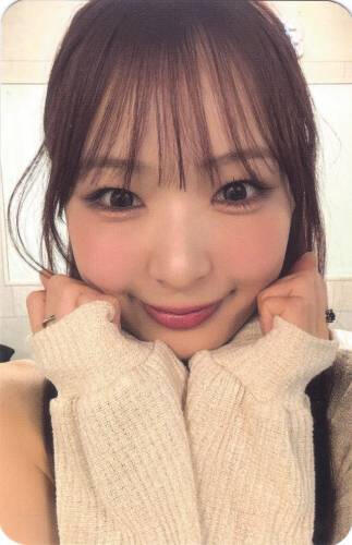 Photocard of Yume resting her face on both hands and smiling