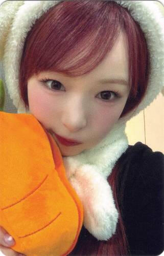 Photocard of Yume wearing a bunny hood and holding a plush carrot by her face