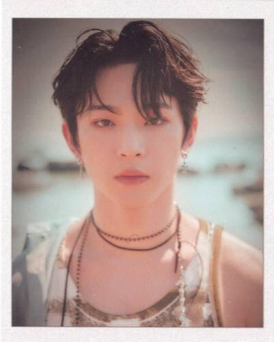 Card of Leedo wearing a tank top at the beach