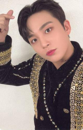 Photocard of Jongho wearing a black and gold outfit and making a finger heart