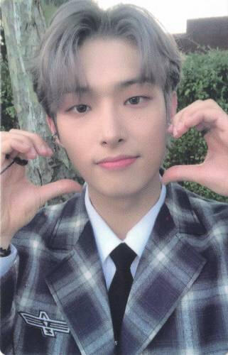 Photocard of Mingi wearing a grey flannel suit and holding two half hand hearts to his face