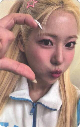 A photocard of Ayeon making a hand heart and kissy face