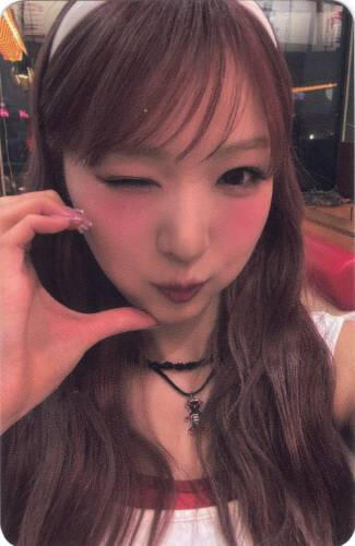 Photocard of Yume making a cheek heart and winking