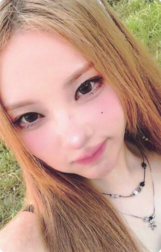 Photocard of Chaein in a grassy field making a scrunched face