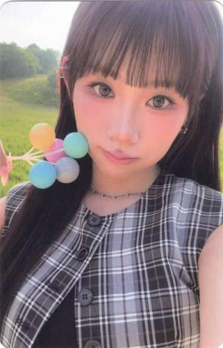 Dosie holding a colourful bundle of spheres to her cheek