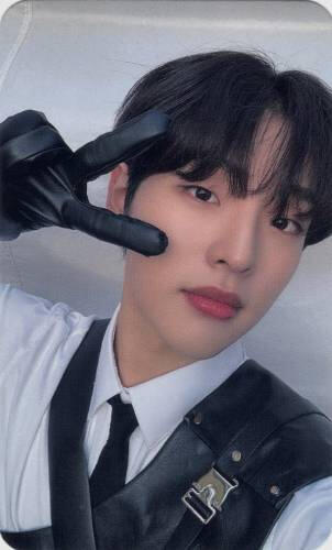 Photocard of Mujin wearing a black leather glove and making a peace sign