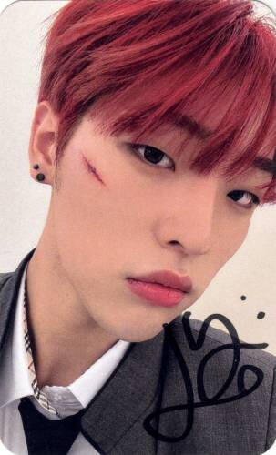 Signed photocard of Mujin with red hair and a cut on his face