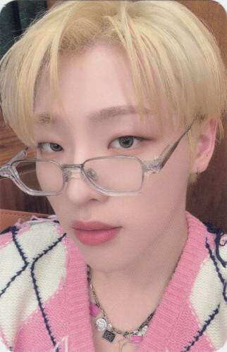 Photocard of Mujin wearing a pink sweater and clear framed glasses