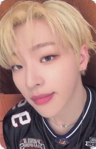 Photocard of Mujin staring at the camera with a light smile