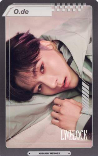A postcard of O.de laying on his side, staring up at the camera