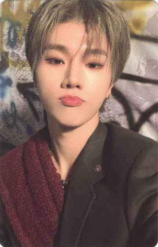 Photocard of Jungsu wearing a black and red suit while slightly pouting