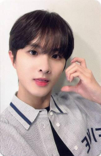 Photocard of Ivan wearing a casual striped button up making a half-heart with an animal ear with his hand against his cheek