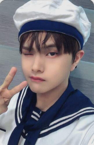 Photocard of Jahan wearing a sailors outfit while winking and making a peace sign