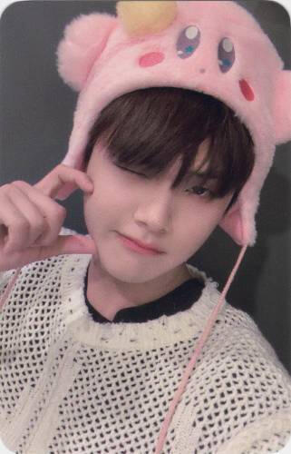 Photocard of Jahan wearing a Kirby hat and making a half heart on his cheek