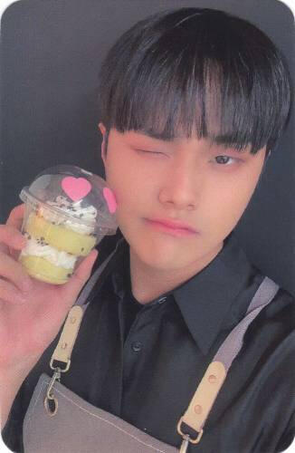Photocard of Jahan holding a pastry by his face