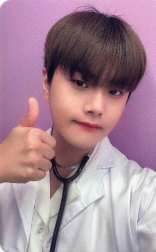 Photocard of Jahan wearing a white lab coat with a stethoscope around his neck, giving a thumbs up