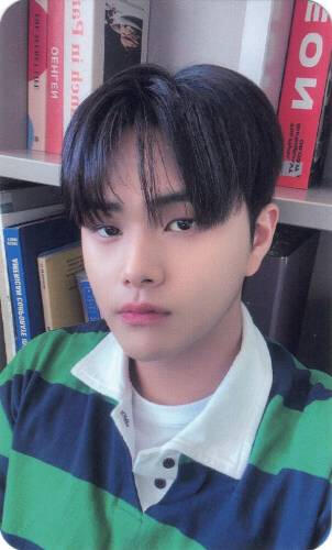 Photocard of Jahan wearing a blue and green striped shirt