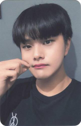 A photocard of Jahan wearing a black shirt and pinching his cheek