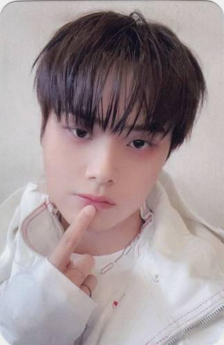 Photocard of Jahan wearing a white shirt and touching his lip